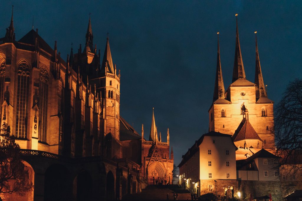 A city at night with a church and spires